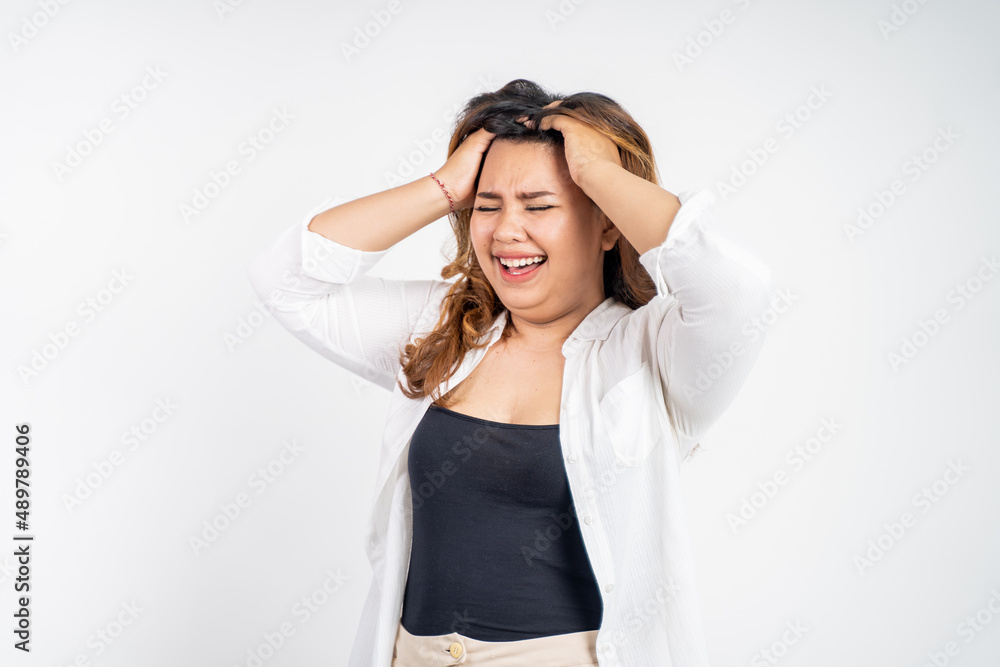 frustrated Asian young woman holding head with headache frustrated Asian young woman holding head with headache
