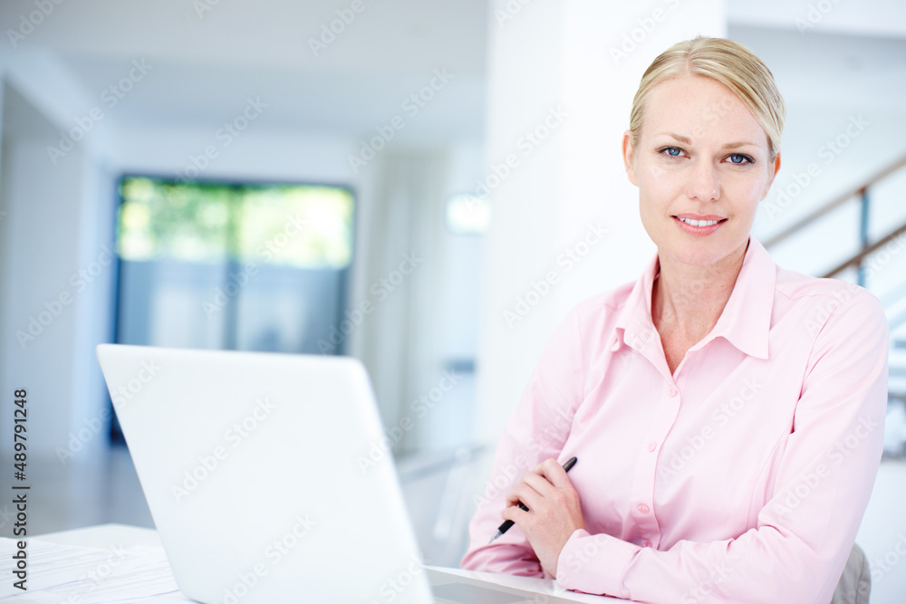 Shes working on a new business model. An attractive female entrepreneur sitting at her desk with her laptop. Shes working on a new business model. An attractive female entrepreneur sitting at her desk with her laptop.