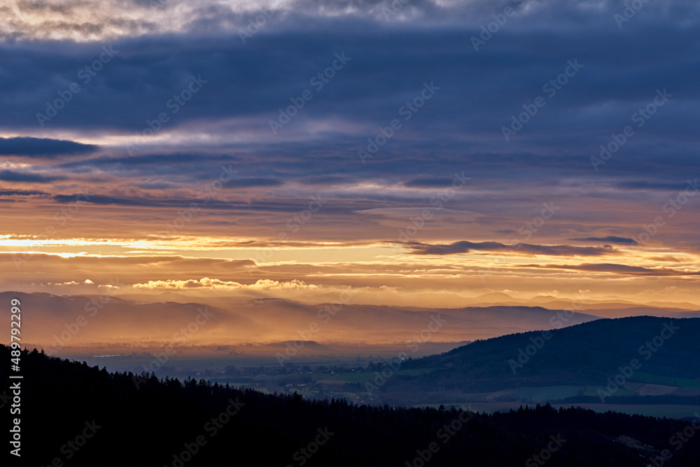 Sunset with dramatic cloudy sky over mountains shape, beautiful nature landscape