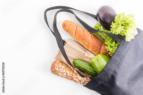 top view of a dark cloth bag filled with organic products . the concept of the right choice of products, zero waste when buying without plastic.