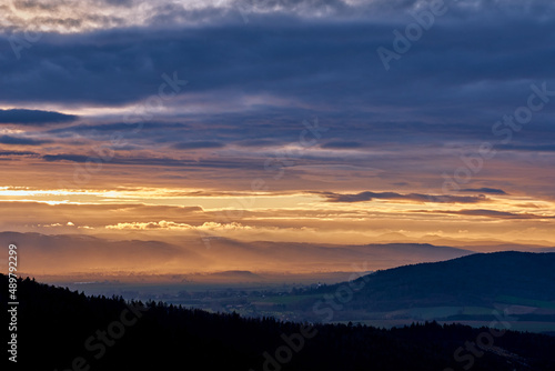 Sunset with dramatic cloudy sky over mountains shape, beautiful nature landscape © Lazy_Bear