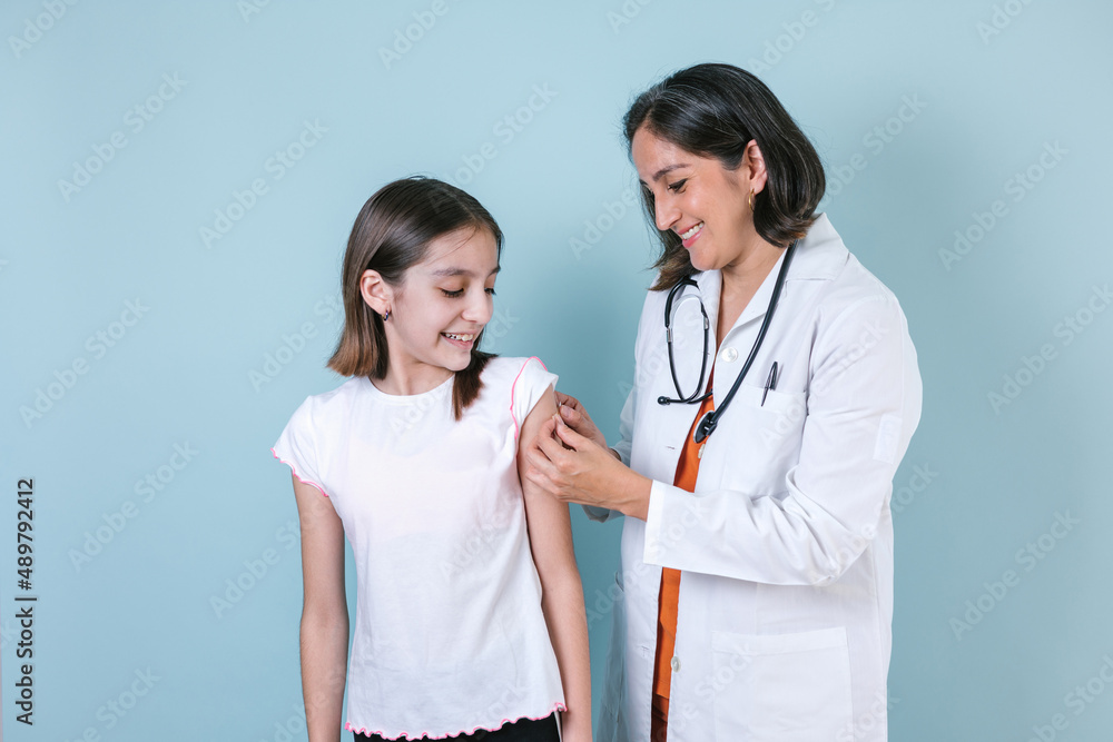 hispanic woman Doctor injecting vaccine to cute hispanic child girl in Mexico Latin America hispanic woman Doctor injecting vaccine to cute hispanic child girl in Mexico Latin America