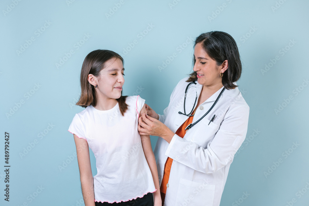 hispanic woman Doctor injecting vaccine to cute hispanic child girl in Mexico Latin America hispanic woman Doctor injecting vaccine to cute hispanic child girl in Mexico Latin America