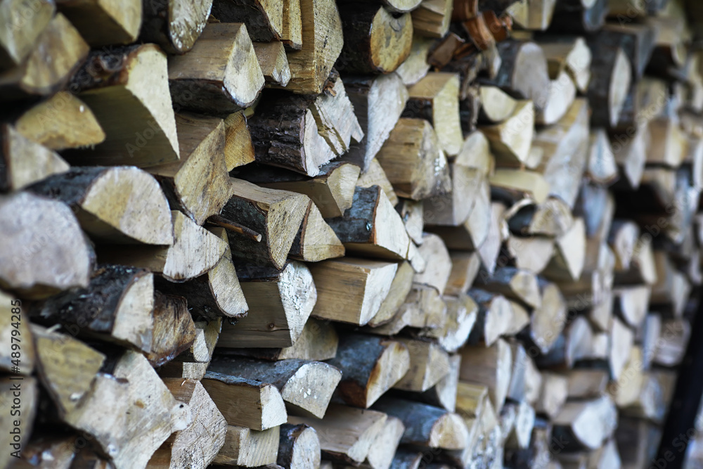 Chopped firewood lies in the woodpile. Wooden background. Chopped firewood lies in the woodpile. Wooden background.