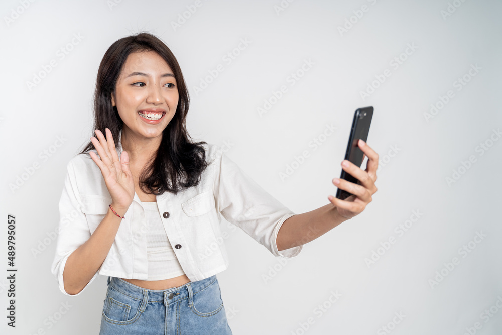 Asian woman holding a smart phone for selfie or video call Asian woman holding a smart phone for selfie or video call