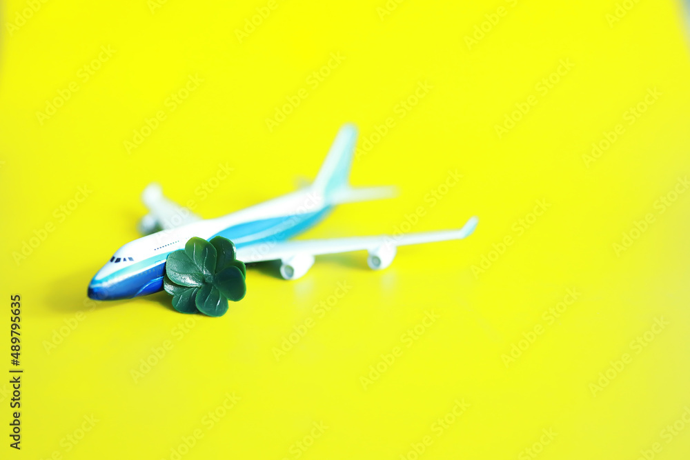 St. patrick's day background. Religious Christian Irish celebration. Four-leaf clover symbol of good luck with airplane. St. patrick's day background. Religious Christian Irish celebration. Four-leaf clover symbol of good luck with airplane.