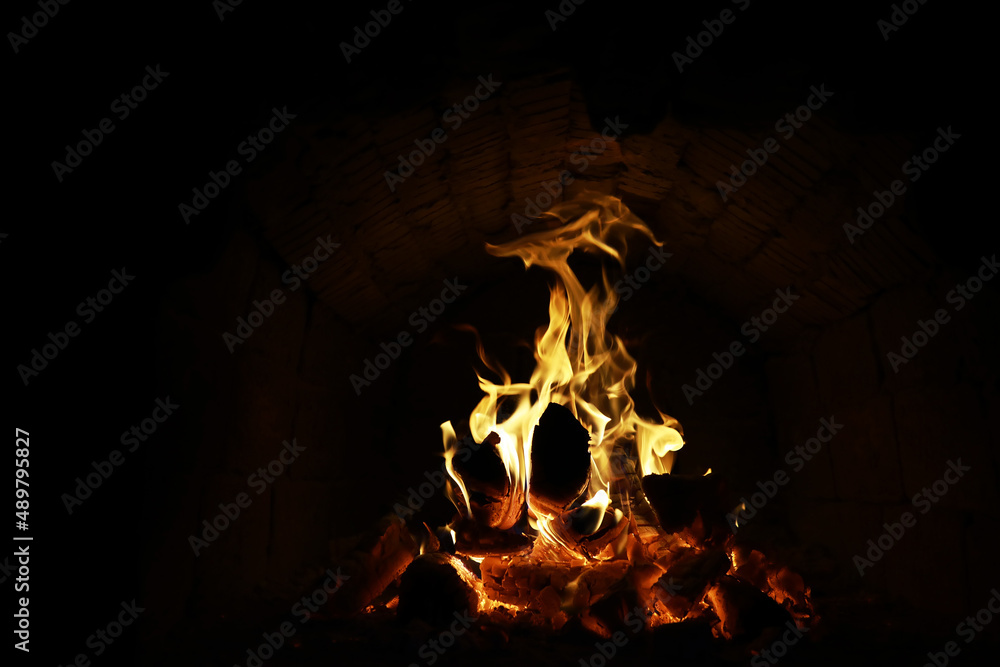 Background of the flame in the oven. Tongues of fire in a brick fireplace. Fire texture. Background of the flame in the oven. Tongues of fire in a brick fireplace. Fire texture.
