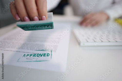 Green approved stamp on document  certificate contract  agreement  lawyer hand
