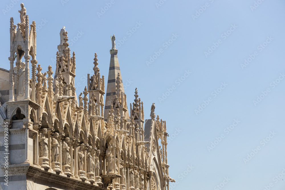 Marble pillars, spires, and statues that are typical of churches in Rome, Italy	