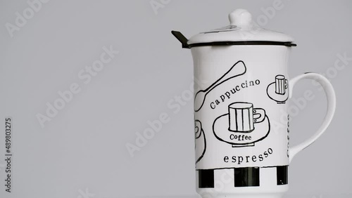 Coffee mug spinning on the right side of the screen - copy space stock video photo