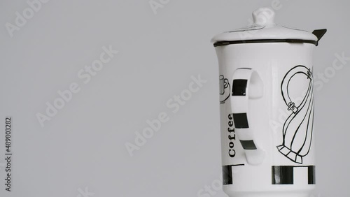 Coffee mug spinning on the right side of the screen - stock video photo