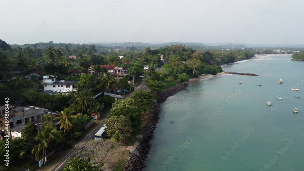 Orbit Shot Of Weligama Eye-catching Waterfront Full Of Green Trees And Large Number Of Anchored Boats, Sri Lanka Orbit Shot Of Weligama Eye-catching Waterfront Full Of Green Trees And Large Number Of Anchored Boats, Sri Lanka
