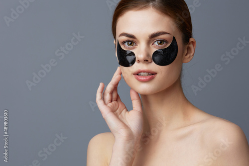 woman skin care anti wrinkle eye patches Gray background