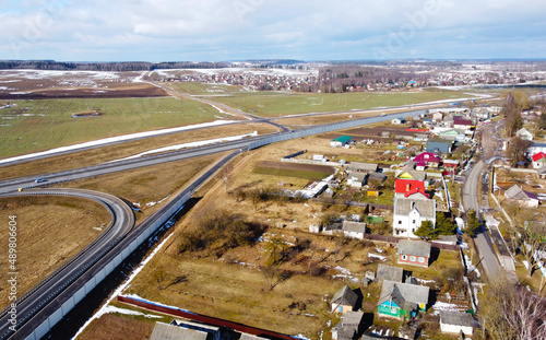 Aerial view of the spring landscape with fields  meadows and suburbs