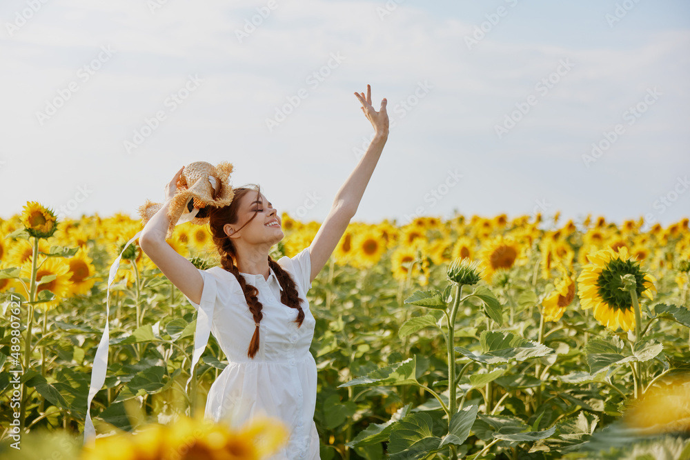 woman with pigtails looking in the sunflower field unaltered woman with pigtails looking in the sunflower field unaltered