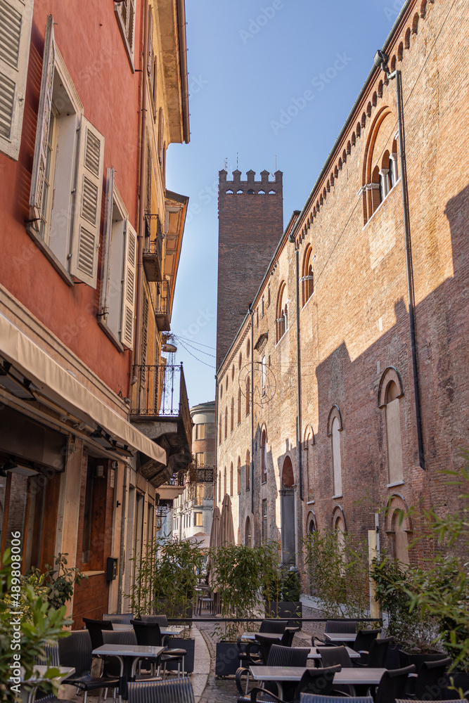 Narrow Street in Cremona with Tables and Chairs of a bar near the Municipal Building, Lombardy - taly