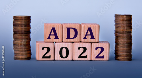 Wallpaper Mural ADA 2022 - acronym on wooden cubes on a light background with coins Torontodigital.ca