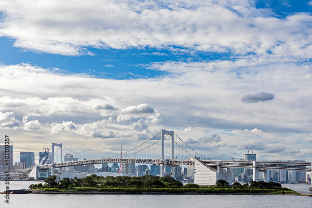 Japan, Kanto Region, Tokyo, Clouds over Odaiba island with Rainbow bridge in background Japan, Kanto Region, Tokyo, Clouds over Odaiba island with Rainbow bridge in background