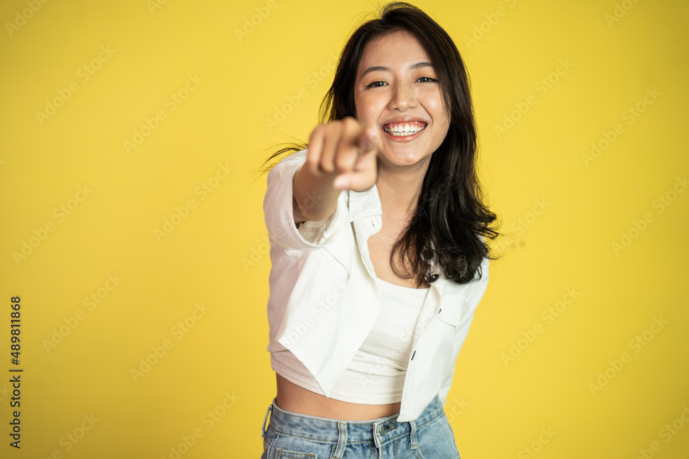 woman smiling while pointing her finger toward camera woman smiling while pointing her finger toward camera