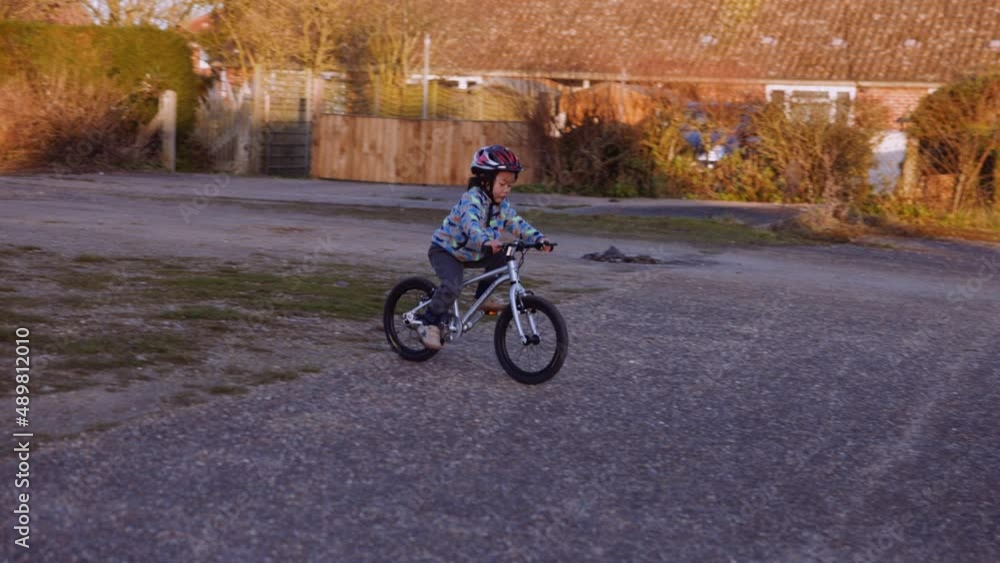 Sunset shot of a young asian boy riding his bike. Sunset shot of a young asian boy riding his bike.