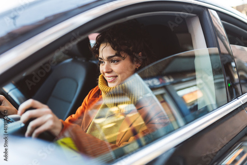 Young woman driving car on road trip photo
