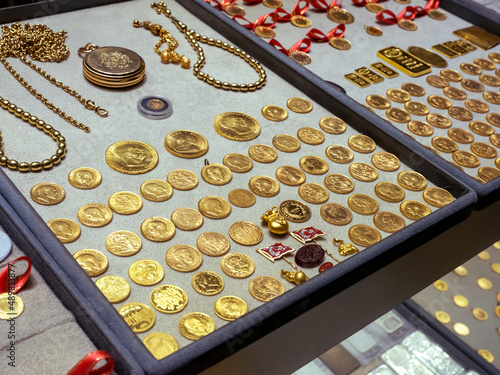 Fototapeta Naklejka Na Ścianę i Meble -  Turkish quarter gold coin with red ribbon