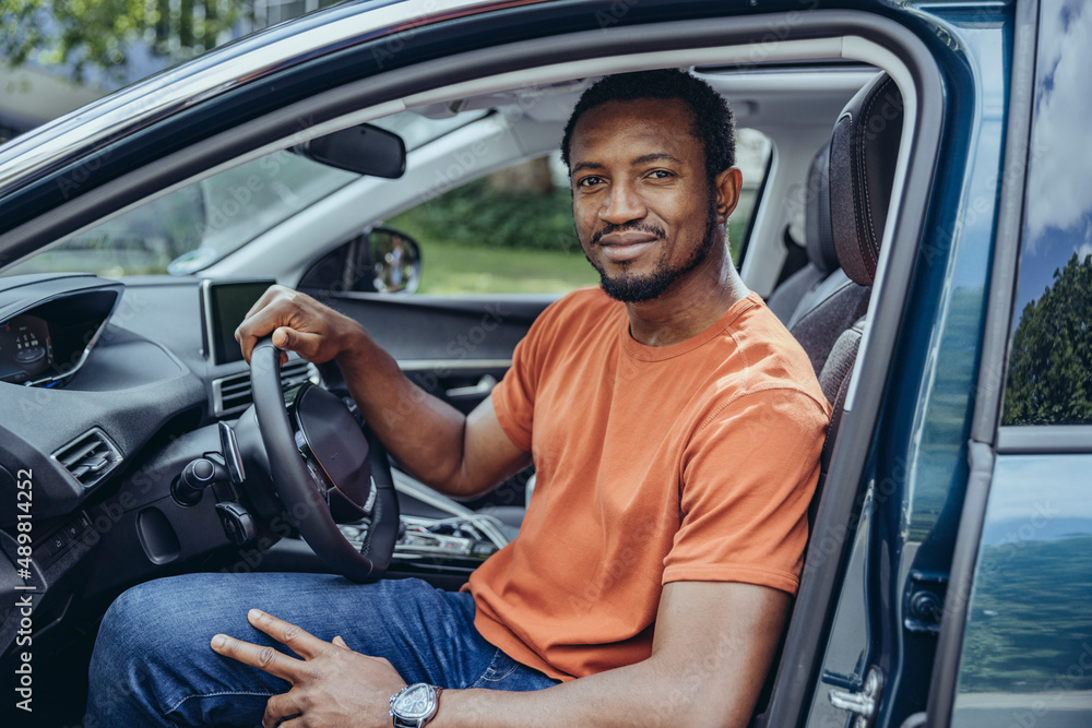 Smiling man sitting in car Smiling man sitting in car