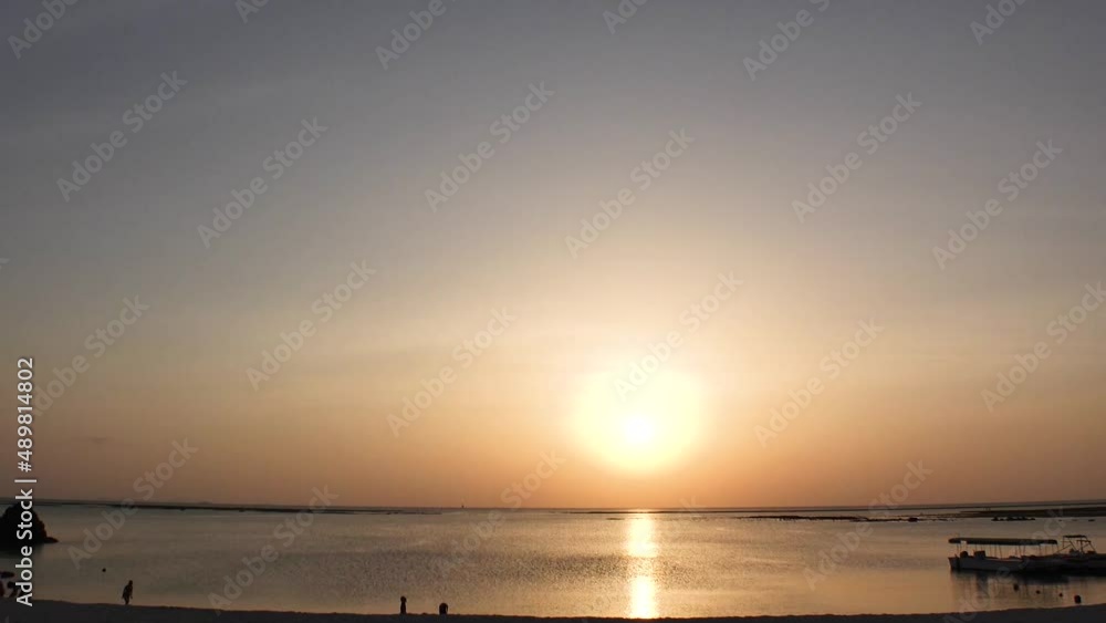 CHTAN-CHO, OKINAWA, JAPAN - AUG 2021 : View of Araha beach (Ocean or sea) in sunset time. Wide view, long time lapse shot, dusk to night. Summer holiday, vacation and resort concept shot. CHTAN-CHO, OKINAWA, JAPAN - AUG 2021 : View of Araha beach (Ocean or sea) in sunset time. Wide view, long time lapse shot, dusk to night. Summer holiday, vacation and resort concept shot.