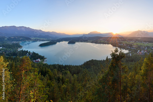 View of Lake Faak at sunset with Karawanks mountains in background photo