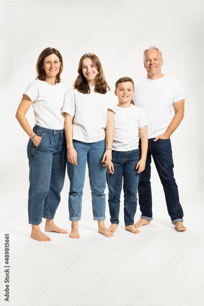 Smiling family standing against white background at studio Smiling family standing against white background at studio