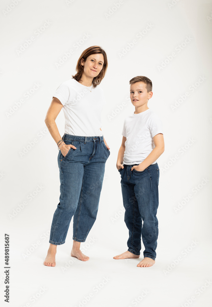 Mother with son standing with hands in pockets at studio Mother with son standing with hands in pockets at studio