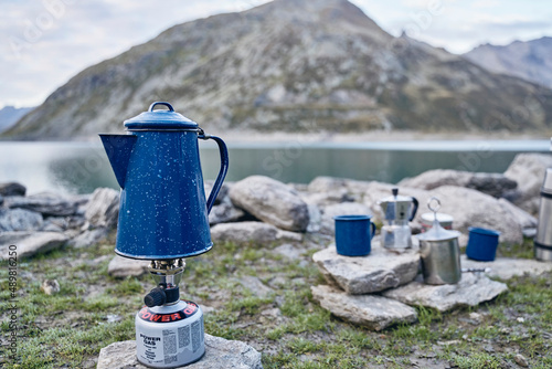 Coffee pot on gas stove burner by lake, Splugen Pass, Sondrio, Italy photo