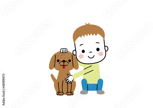笑顔で並んで座っている男の子と犬　