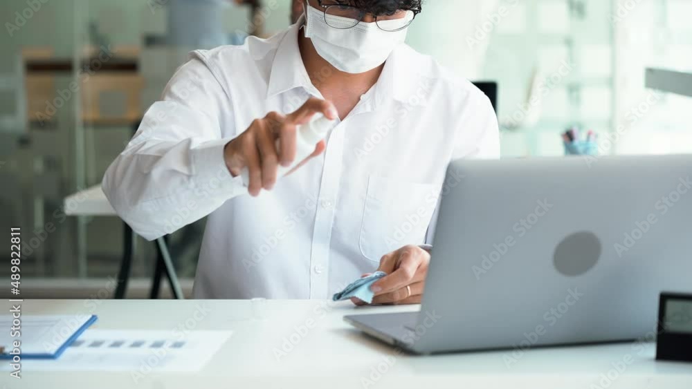 Employees are spraying with alcohol to wipe clean office equipment. Employees are spraying with alcohol to wipe clean office equipment.
