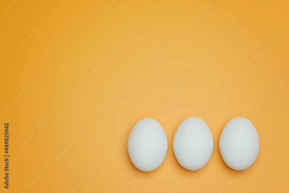 Three white chicken eggs on yellow background top view. Creative food minimalistic background.