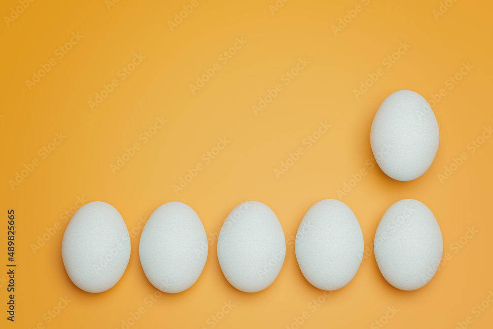 Six white chicken eggs on yellow background top view. Creative food minimalistic background. Six white chicken eggs on yellow background top view. Creative food minimalistic background.
