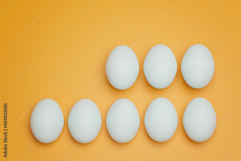 Eight white chicken eggs on yellow background top view. Creative food minimalistic background. Eight white chicken eggs on yellow background top view. Creative food minimalistic background.