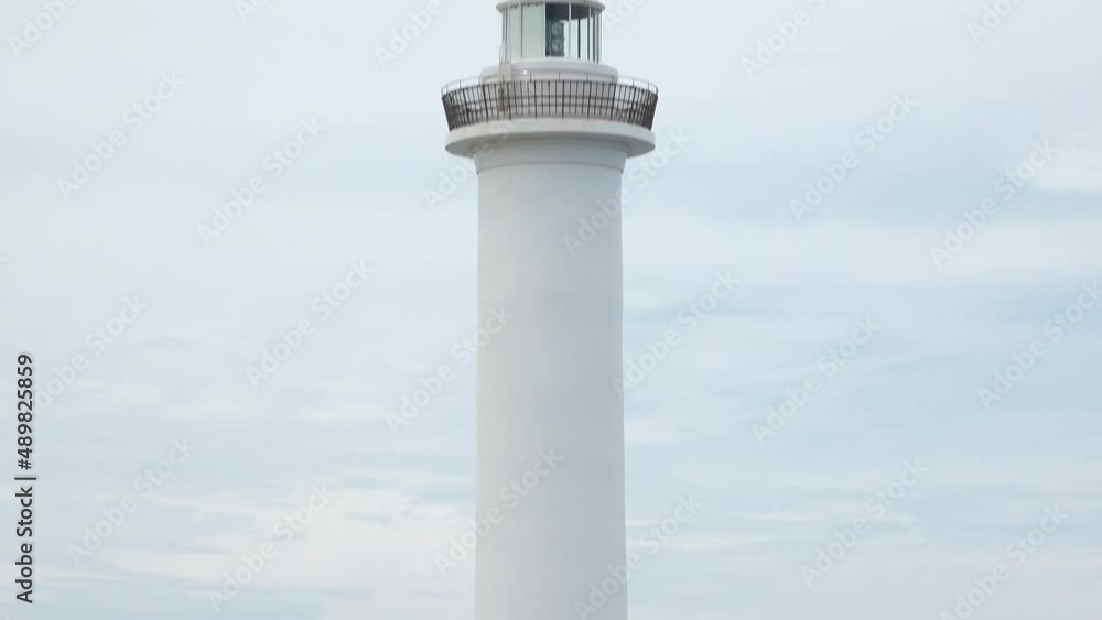 YOMITANSON, OKINAWA, JAPAN - AUGUST 2021 : View of lighthouse at Zanpa Misaki (Cape Zanpa) and East China Sea (Ocean) in daytime. Summer holiday, vacation and resort concept video. YOMITANSON, OKINAWA, JAPAN - AUGUST 2021 : View of lighthouse at Zanpa Misaki (Cape Zanpa) and East China Sea (Ocean) in daytime. Summer holiday, vacation and resort concept video.
