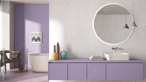 Cozy minimalist bathroom in purple pastel tones  washbasin with mirror  bathtub  tiles and concrete walls  armchair  colored vases and decors  interior design project concept idea