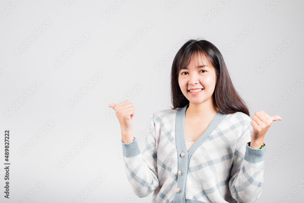 Happy woman smile showing finger thumbs up, Portrait Asian beautiful young female successful like finger gesture, OK sign to agree studio shot isolated on white background with copy space Happy woman smile showing finger thumbs up, Portrait Asian beautiful young female successful like finger gesture, OK sign to agree studio shot isolated on white background with copy space