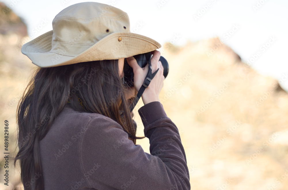 Capturing the wild. A young woman taking pictures outside. Capturing the wild. A young woman taking pictures outside.