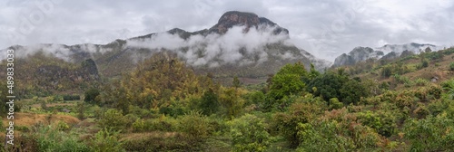 Scenic morning rural panorama of beautiful agricultural mountain valley with low clouds in the Chiang Dao countryside, Chiang Mai, Thailand