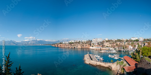 Fototapeta Naklejka Na Ścianę i Meble -  View of Antalya Old City Harbor, the Taurus Mountains and the spelling of the Mediterranean Sea