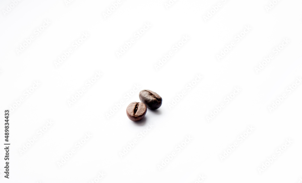 Two coffee beans on a white background. Isolated coffee beans. Two coffee beans on a white background. Isolated coffee beans.