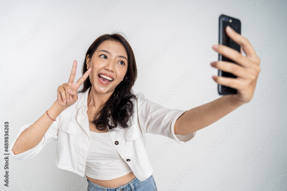 Asian woman holding a smart phone for selfie or video call Asian woman holding a smart phone for selfie or video call