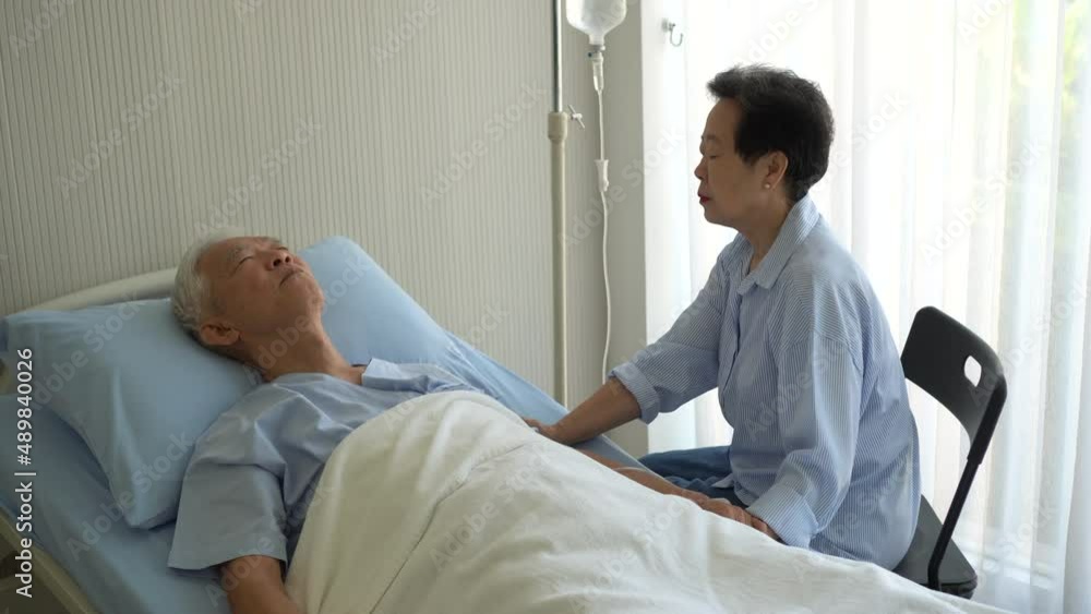 Asian senior couple taking care wife taking care of husband admit at hospital bed sickness Asian senior couple taking care wife taking care of husband admit at hospital bed sickness