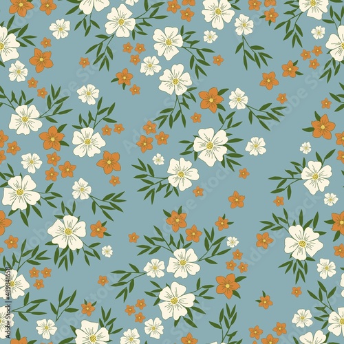 Seamless vintage pattern. White and orange flowers  green leaves. Blue background. vector texture. fashionable print for textiles  wallpaper and packaging.