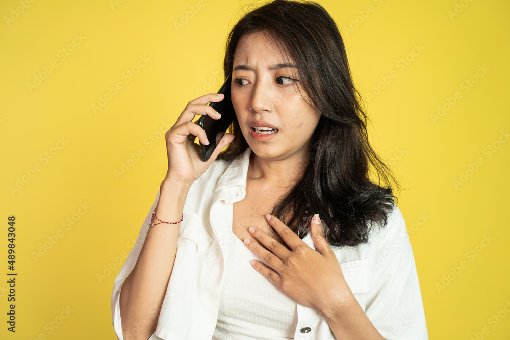 worried woman when making a call using a cell phone worried woman when making a call using a cell phone