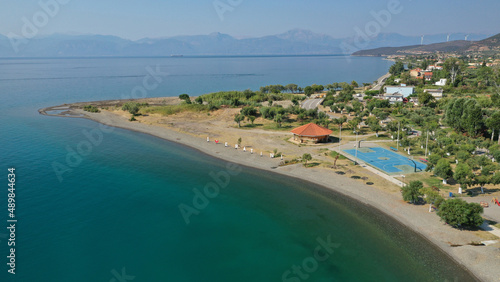 Aerial drone photo of picturesque seaside village and beach of Eratini in Fokida prefecture as seen in summer, Greece