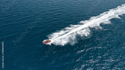 Aerial photo of jet ski with couple cruising in high speed in Caribbean tropical crystal clear deep blue waters © aerial-drone